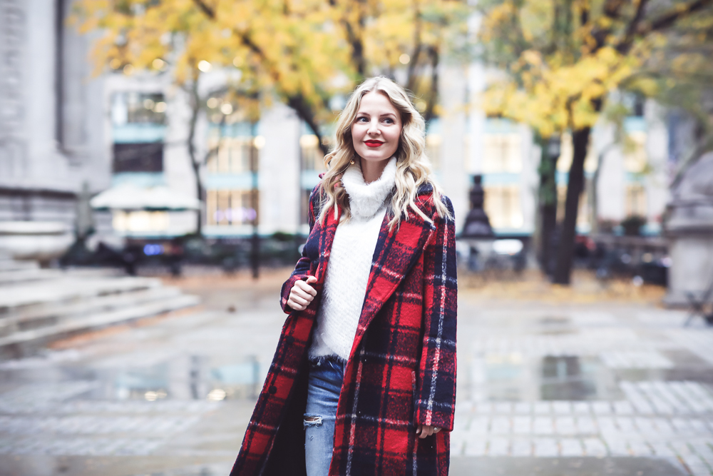 Plaid coat by cupcakes and cashmere in red and navy, with Moussy Jeans, fuzzy white sweater from Bloomingdales, and black patent britsy boots on fashion blogger, Erin Busbee from Busbee Style by NYC public library