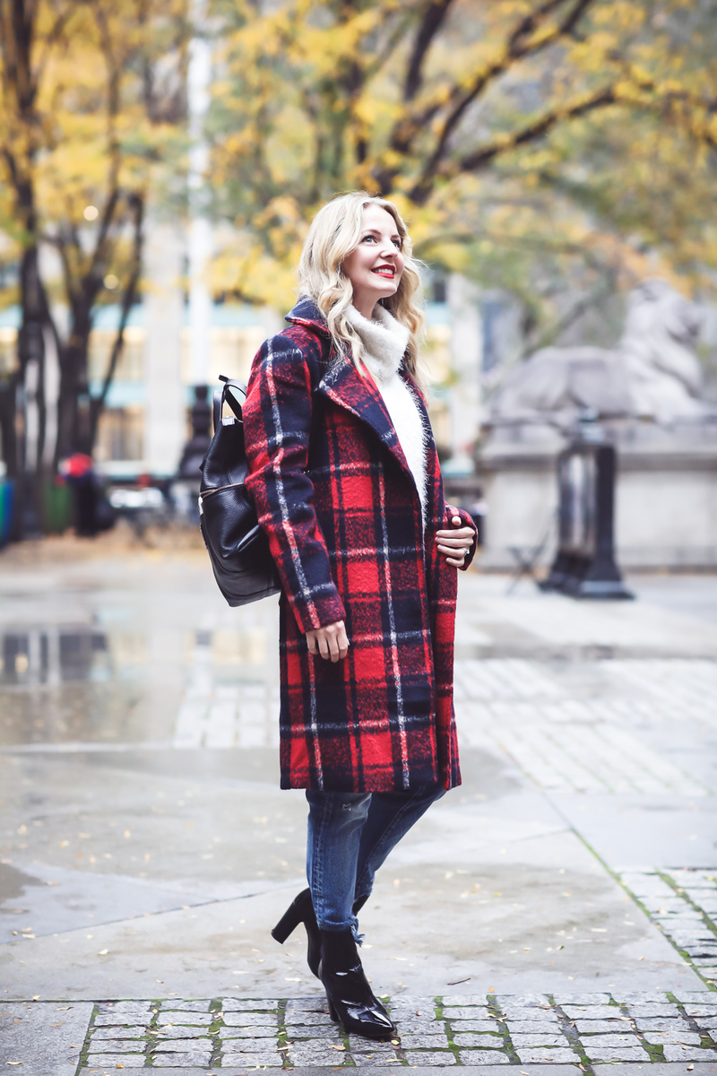 Plaid coat, this one is by cupcakes and cashmere in red and navy, with Moussy Jeans, fuzzy white sweater from Bloomingdales, and black patent britsy boots on fashion blogger, Erin Busbee from Busbee Style