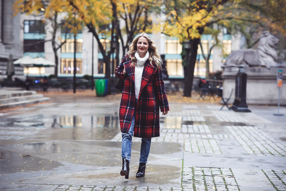 Plaid coat by cupcakes and cashmere in red and navy, with Moussy Jeans, fuzzy white sweater from Bloomingdales, and black patent britsy boots on fashion blogger, Erin Busbee from Busbee Style by NYC public library