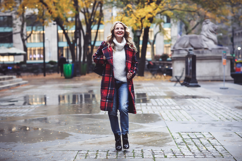 Plaid coat, this one is by cupcakes and cashmere in red and navy, with Moussy Jeans, fuzzy white sweater from Bloomingdales, and black patent britsy boots on fashion blogger, Erin Busbee from Busbee Style