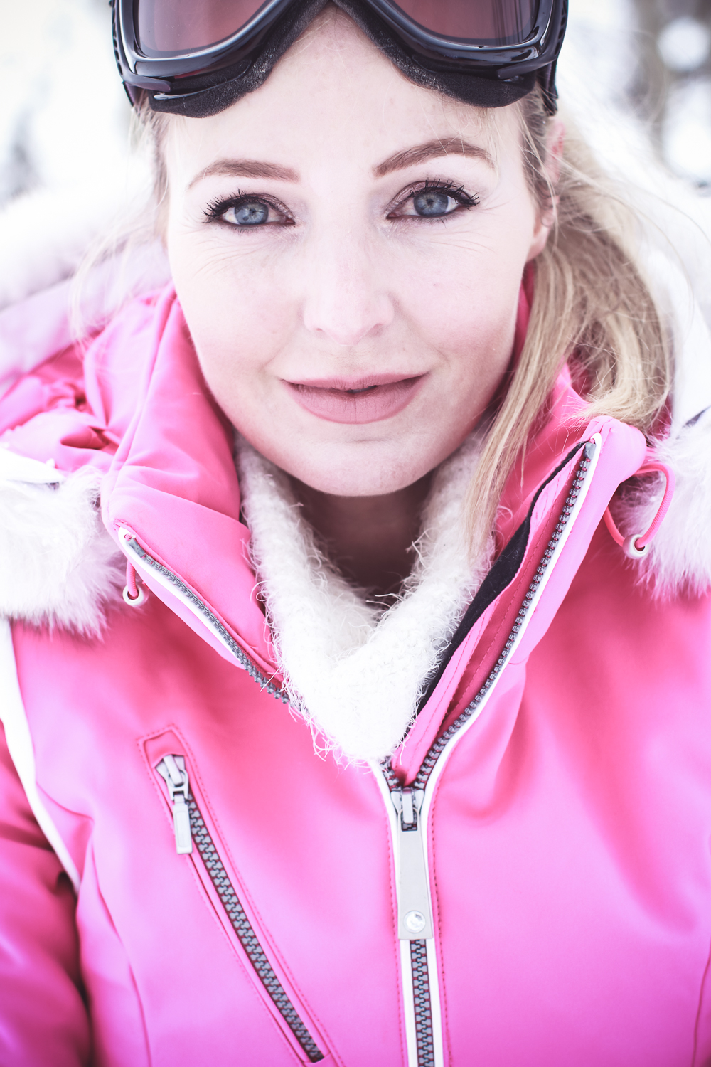 Fitness routine update, featuring lifestyle blogger over 40, Erin Busbee of Busbee Style, talking about skiing as great cardio wearing Nils US pink ski jacket, and Toni Sailer white ski pants