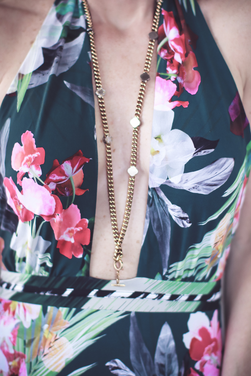 Best accessories featuring a beautiful gold and silver necklace from Henri Bendel on fashion blogger over 40, Erin Busbee of Busbee Style wearing a La Blanca tropical print one piece swimsuit