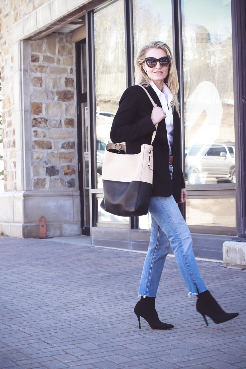 Blazer 2 Ways on fashion blogger over 40, Erin Busbee of Busbee Style wearing Madewell black blazer, Moussy tapered jeans, white button down and Henri bendel color block tote with Hifi Stuart Weitzman black sock booties