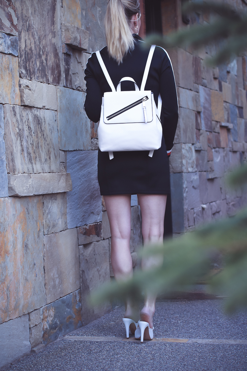 White sporty handbag backpack on fashion blogger Erin busbee of busbeestyle.com