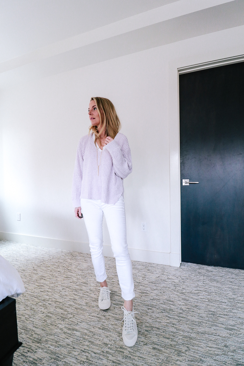 White skinny jeans paired with a lavender tunic sweater from Express and white perforated sneakers by Tretorn on fashion blogger Erin Busbee of Busbee Style 