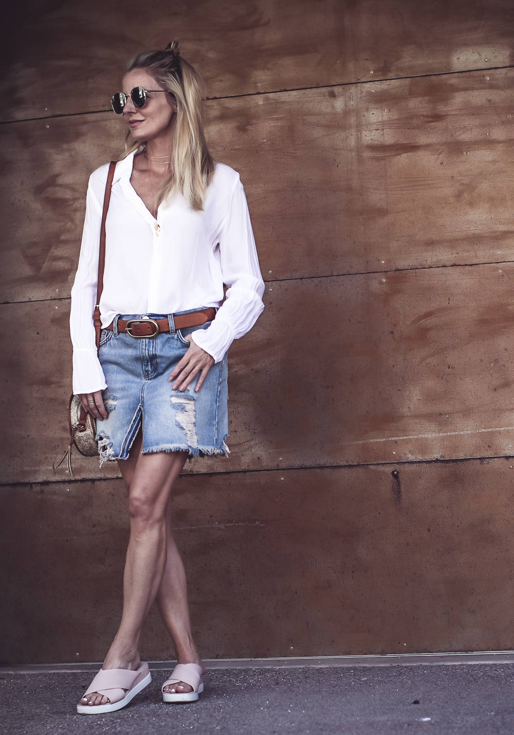 Comfortable sandals, slides by ECCO on blonde woman wearing distressed denim skirt by Free People and white button down shirt by Bella Dahl