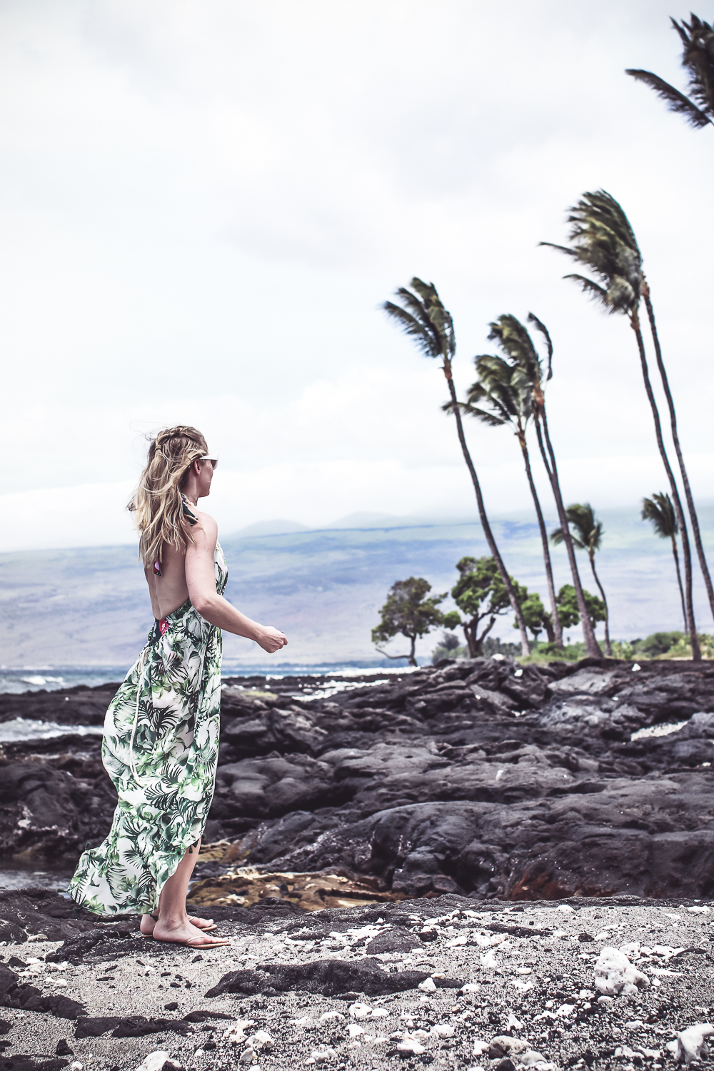 Palm prints fashion trend 2018, blond woman wearing palm print cover up on the beach in Hawaii on the Big Island