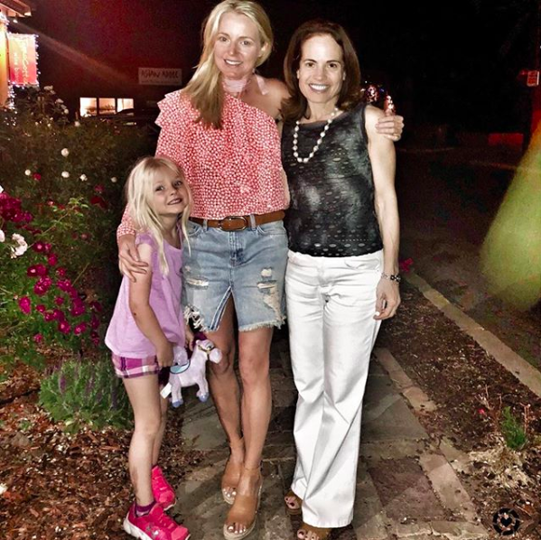 blonde woman wearing a one shoulder ruffle top and denim skirt with treasure & bond wedges standing with daughter and friend in Santa Fe, part of Instagram roundup