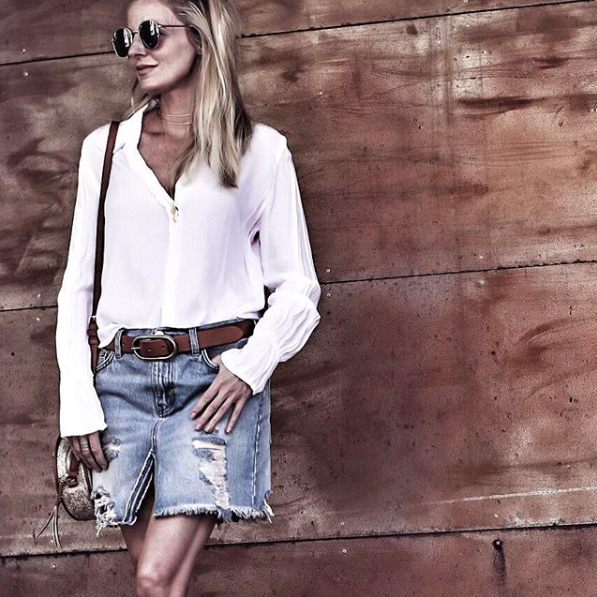 blonde woman in telluride, colorado wearing a white button down blouse and distressed denim skirt from Shopbop, sunglasses, and a straw circle bag, part of instagram roundup
