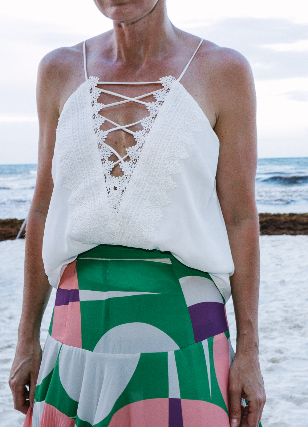 Maxi Skirts, my picks including this gorgeous pleated pink and green maxi skirt by Alexis paired with a WAYF lace up cami in white on the beach in Tulum, Mexico