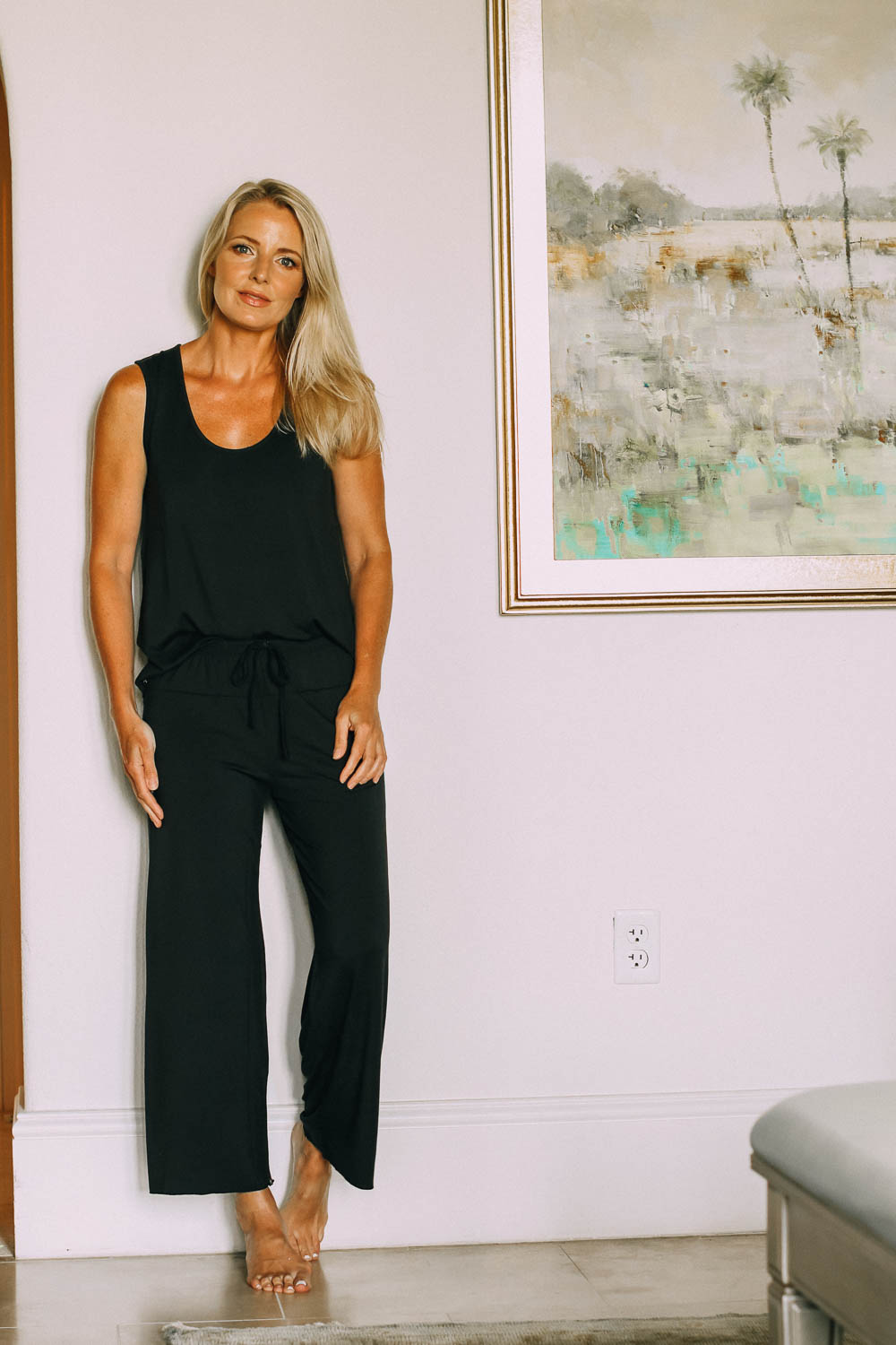 best pajamas, black luxe jersey sleeveless top and cropped pants pajamas set by Barefoot Dreams on blonde woman