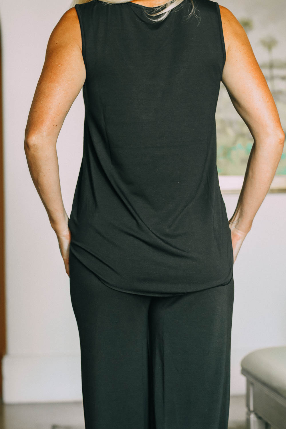 best pajamas, black luxe jersey sleeveless top and cropped pants pajamas set by Barefoot Dreams on blonde woman