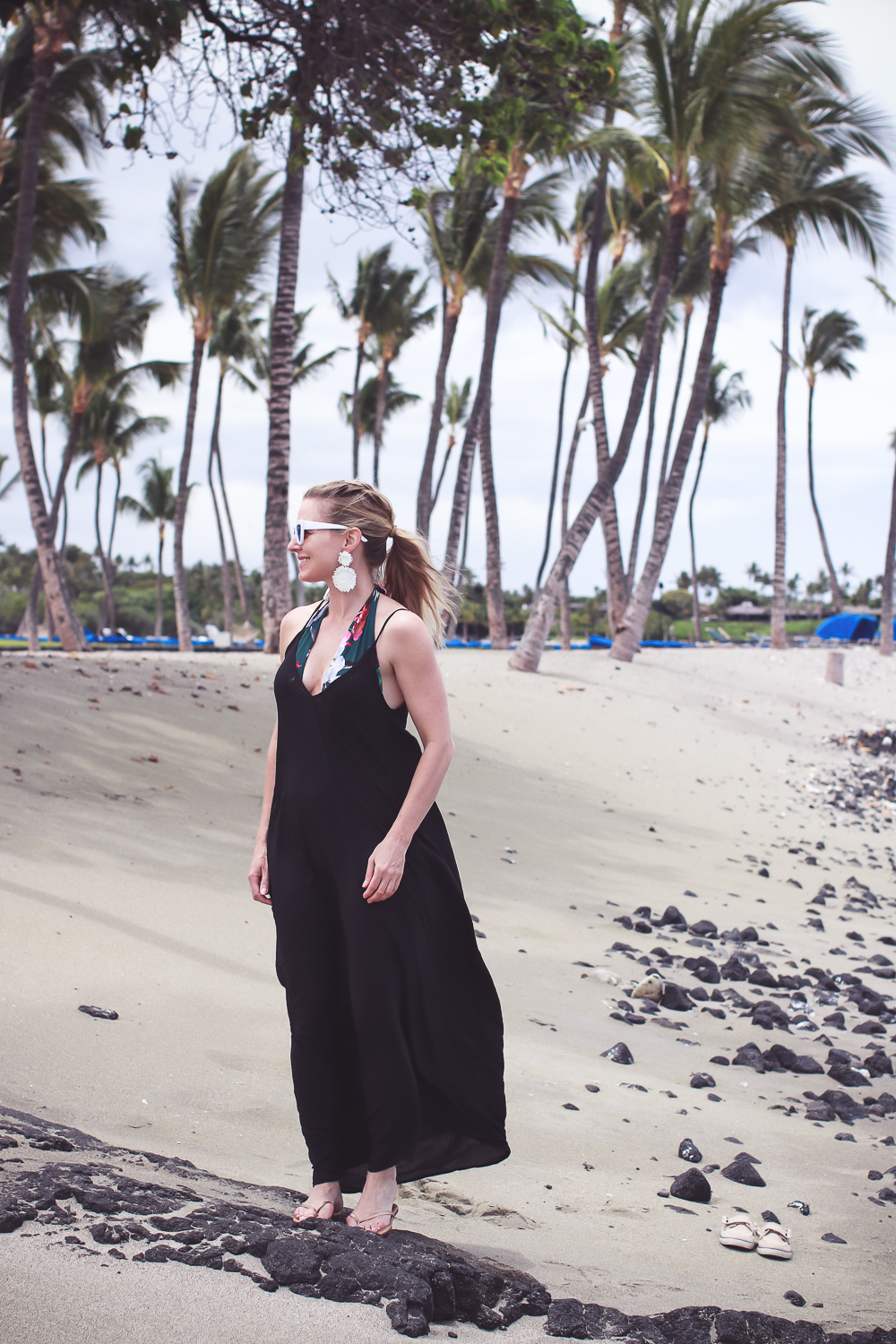 favorite beach or pool swim coverups on blonde woman featuring a black Elan maxi dress with pockets and La Blanca tropical jungle one piece swimsuit with white retro sunglasses