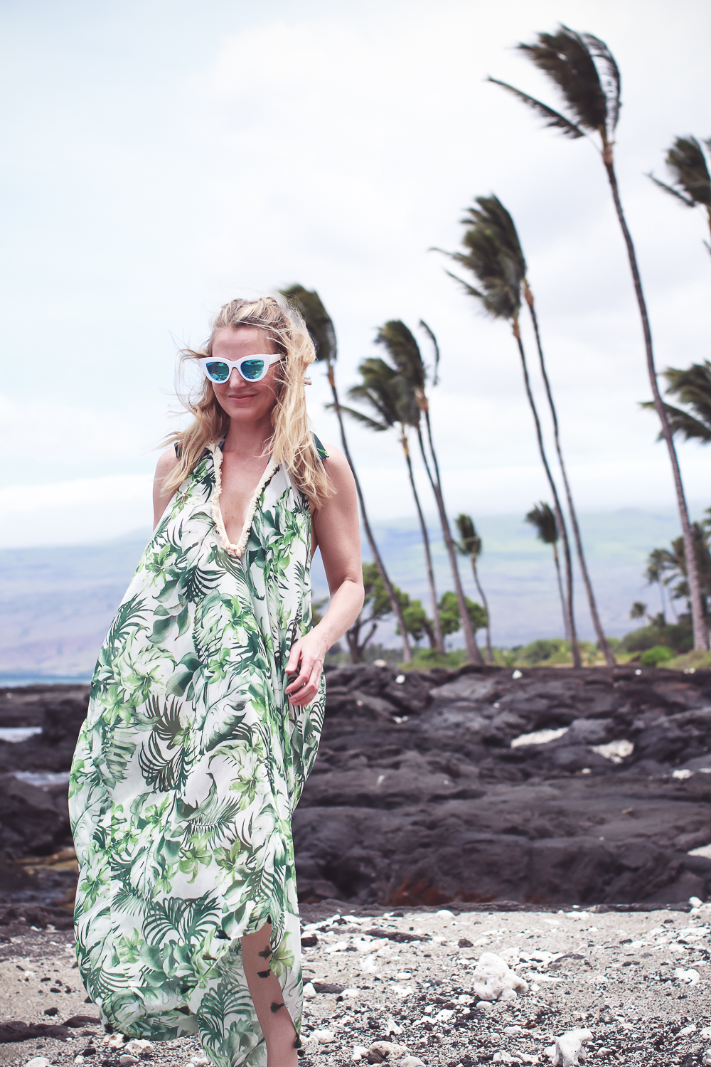 favorite beach or pool swim coverups on blonde woman featuring a palm print flowy coverup and La Blanca tropical jungle one piece swimsuit with white retro sunglasses