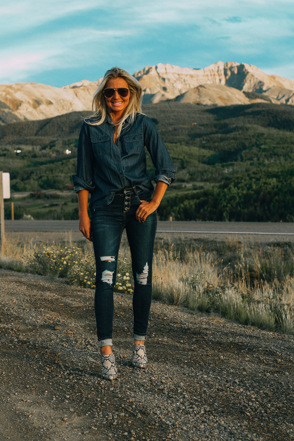 Affordable fall fashion from JCPenney's, including a chambray button down shirt, paired with distressed blue jeans, python mules and aviator sunglasses on fashion blogger Erin Busbee of BusbeeStyle.com