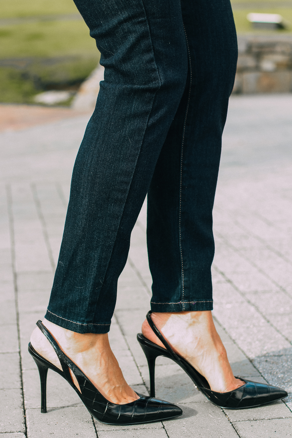 Best Jeans for Curves by Not Your Daughter's Jeans or NYDJ paired with black of shoulder dolman top, Quay aviator sunglasses, gold earrings on fashion blogger over 40, Erin Busbee of busbee style, five shoes you need this fall