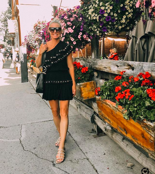 woman with blonde hair in bun wearing a black Misa Los Angeles dress and Sam edelman sandals in telluride, colorado, what i wore
