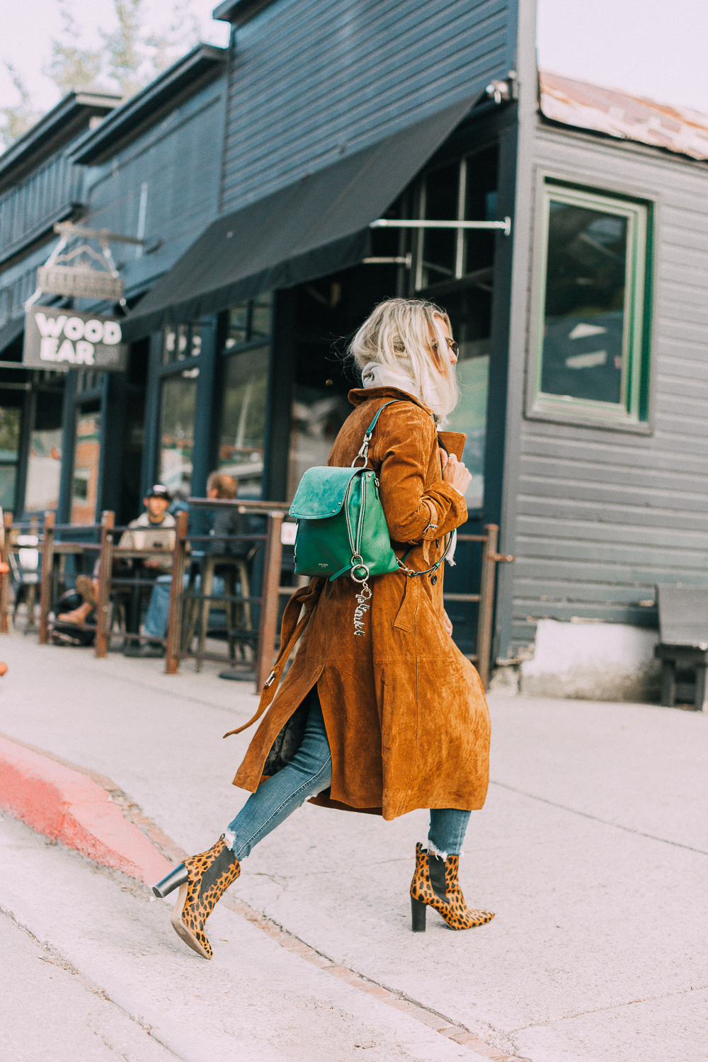 Green suede backpack by Henri Bendel paired with distressed jeans and leopard print ankle booties, brown long suede trench on blonde fashion blogger in telluride, Colorado