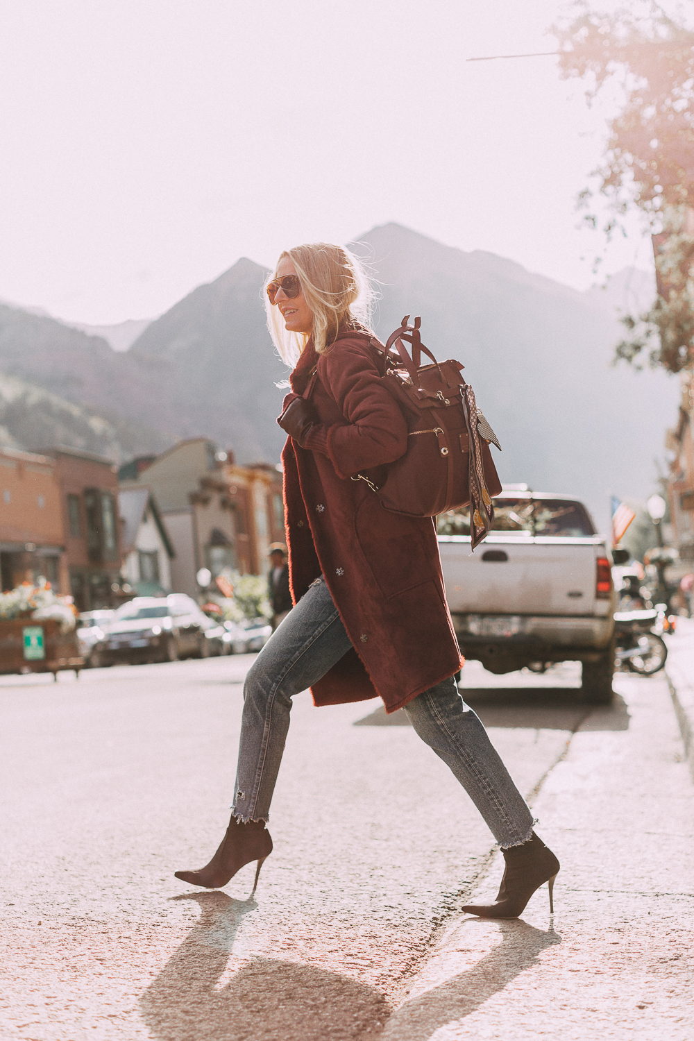 burgundy Jetsetter backpack paired with burgundy plush coat, cropped Moussy jeans, Stuart Weitzman sock booties and fingerless gloves, Only Bag You'll Ever Need