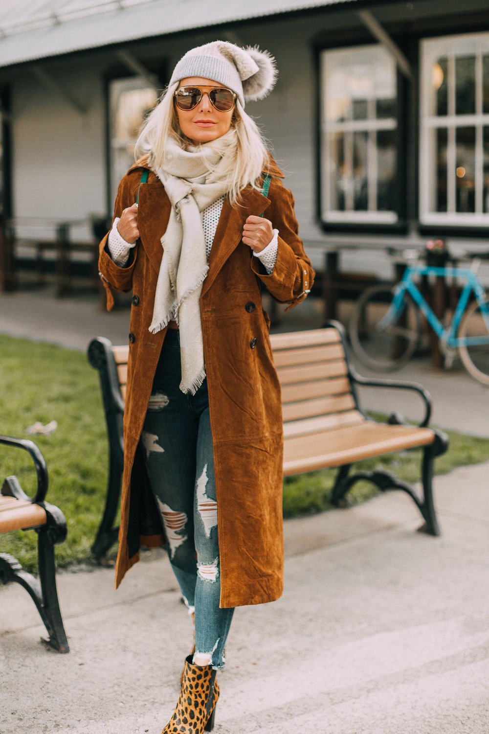 Green suede backpack by Henri Bendel paired with distressed jeans and leopard print ankle booties, brown long suede trench on blonde fashion blogger in telluride, Colorado