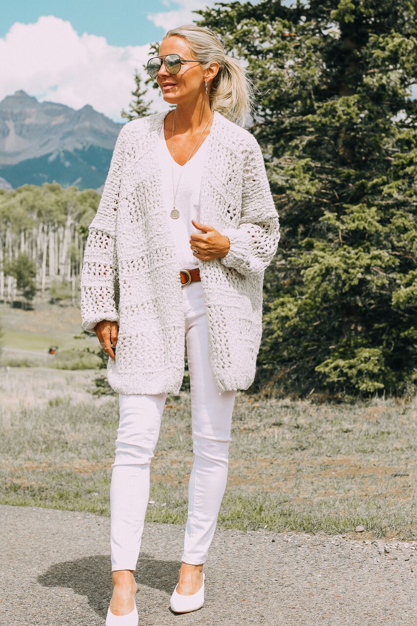 blonde woman in colorado wearing am all white look with free people cardigan, white skinny jeans, and a white tee