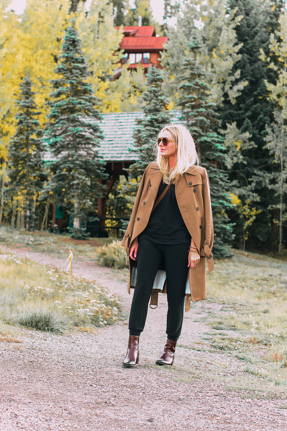 ankle boots for walking in Bison brown with low block heel and comfort, cushion technology by ECCO on fashion blogger in black joggers by Norma Kamali and black off shoulder top with brown crossbody bag