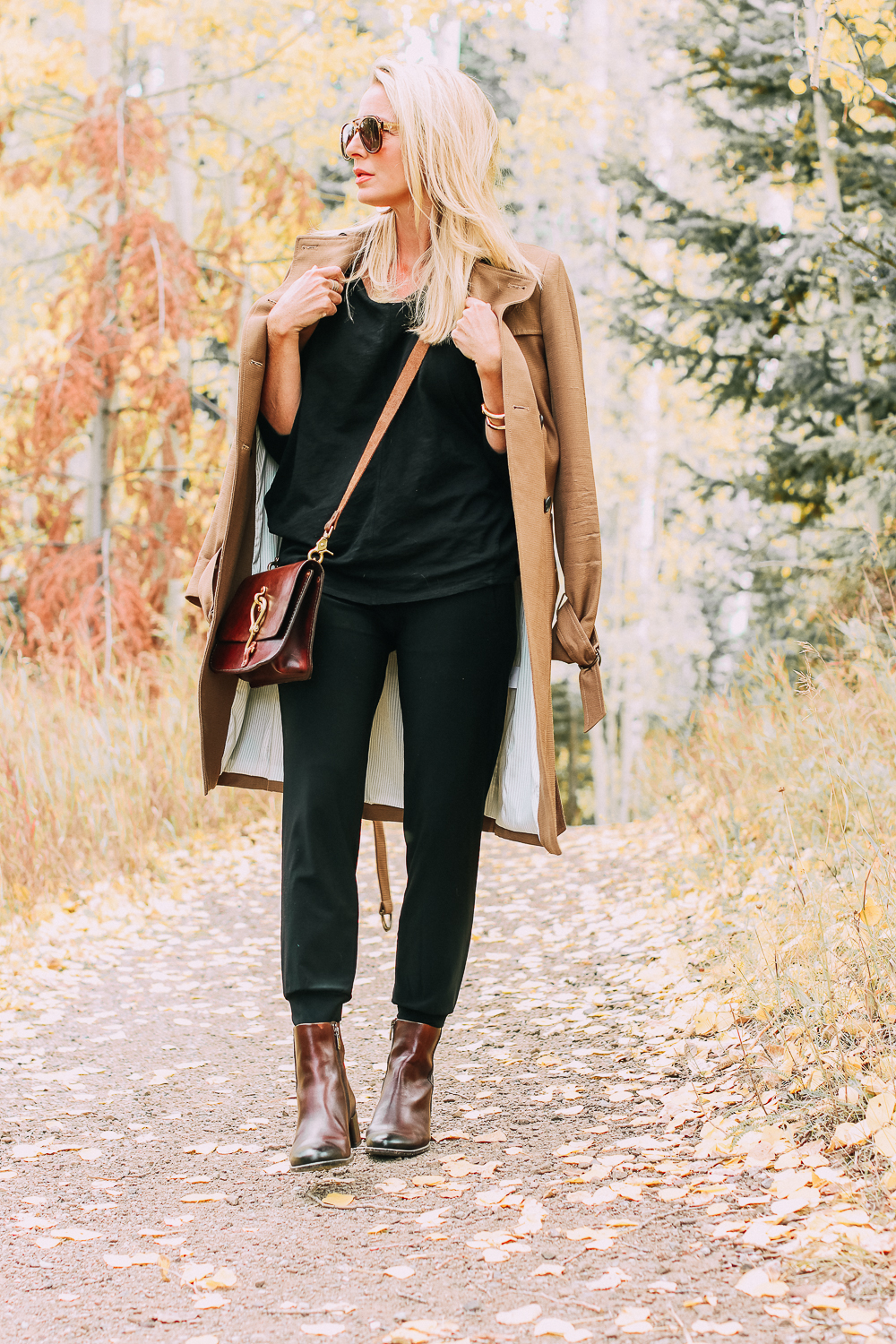 ankle boots for walking in Bison brown with low block heel and comfort, cushion technology by ECCO on fashion blogger in black joggers by Norma Kamali and black off shoulder top with brown crossbody bag