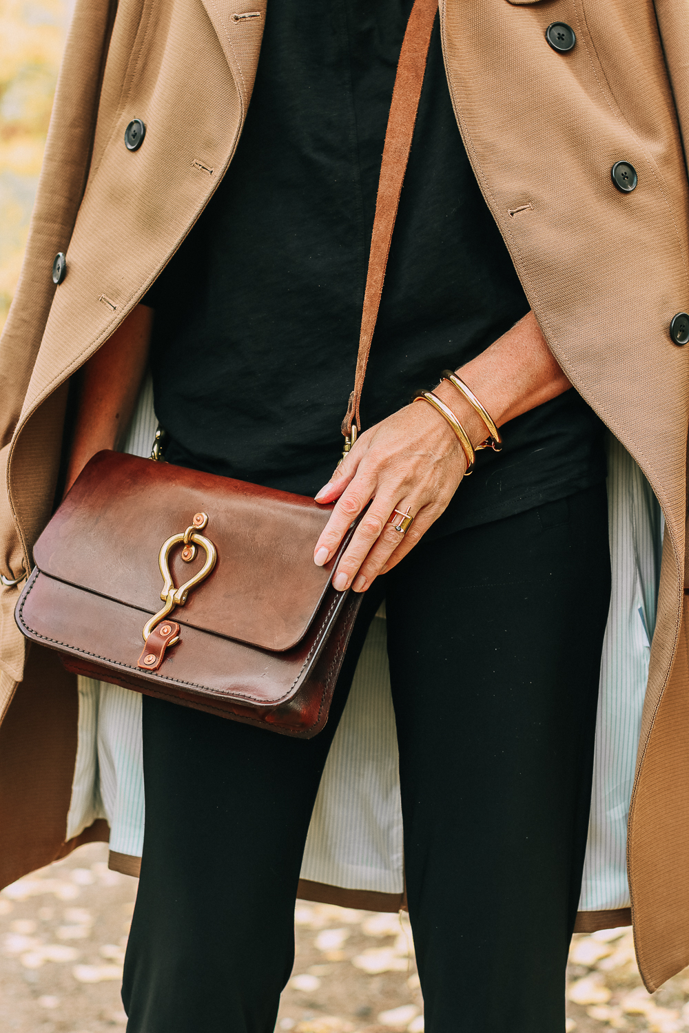 ankle boots for walking in Bison brown with low block heel and comfort, cushion technology by ECCO on fashion blogger in black joggers by Norma Kamali and black off shoulder top with brown crossbody bag