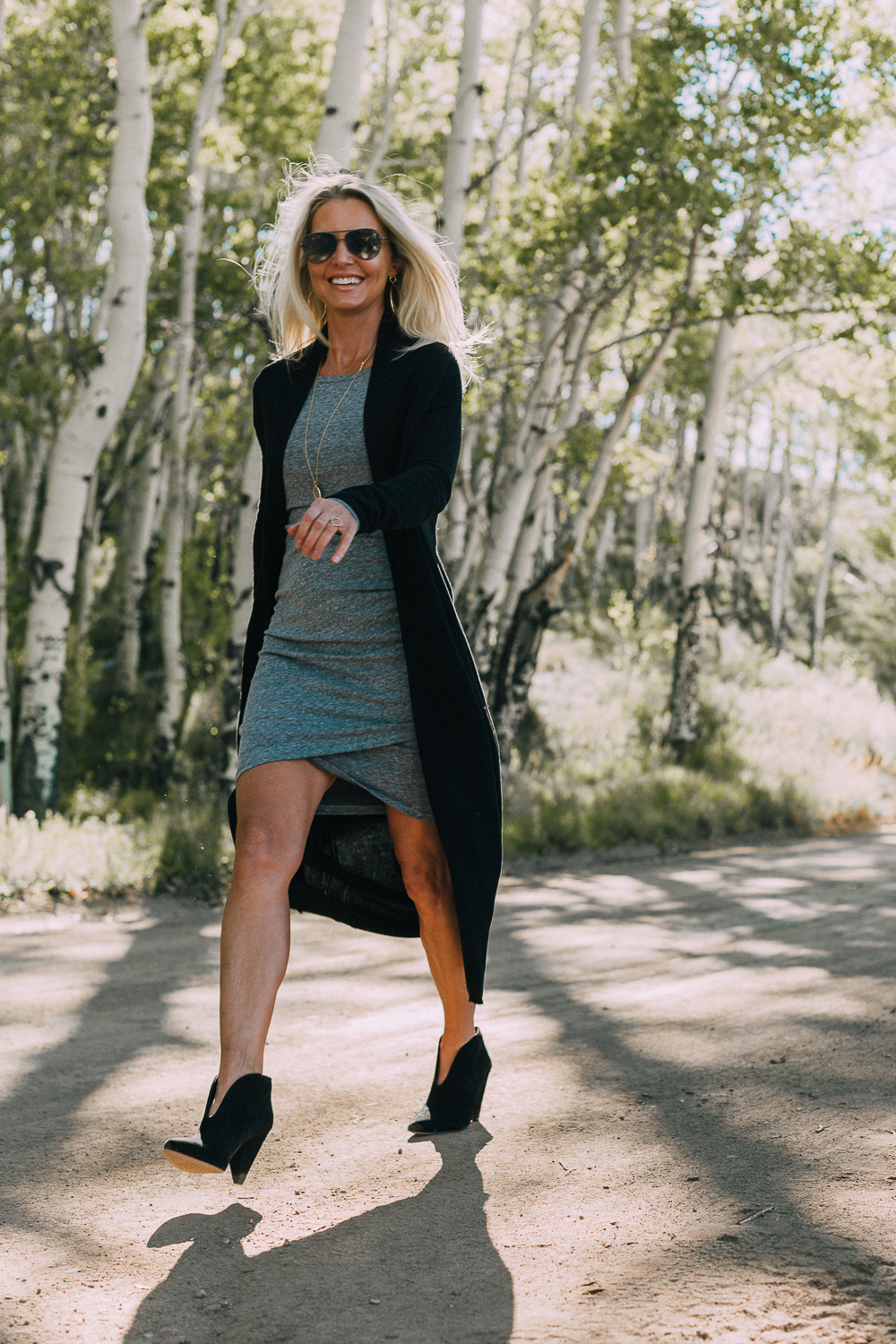 fall booties 2018 featuring black dressy booties by Vince Camuto in black suede paired with a ruched gray t-shirt dress with long sleeves and a long black cardigan sweater on fashion blogger over 40, Erin Busbee of Busbee Style