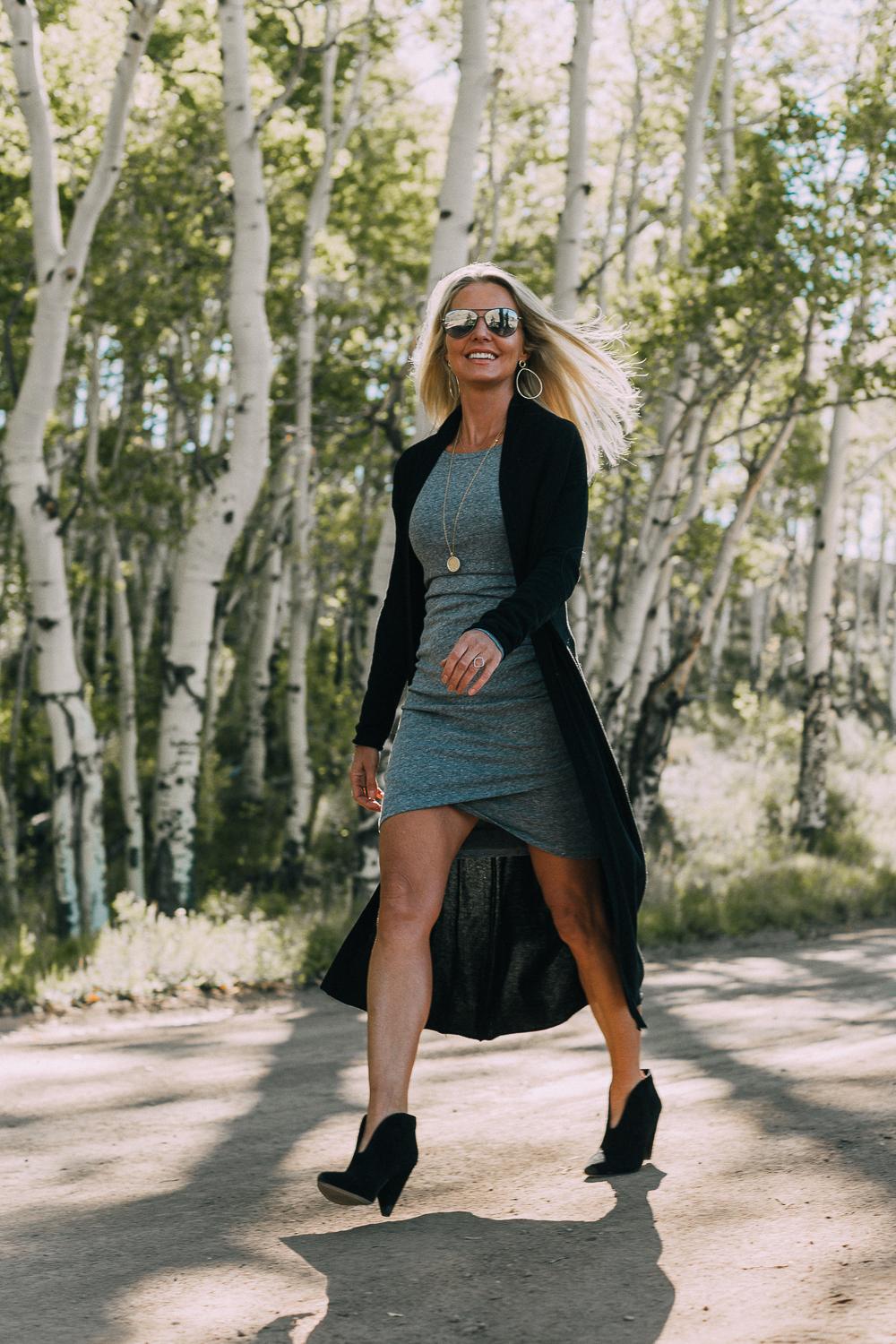fall booties 2018 featuring black dressy booties by Vince Camuto in black suede paired with a ruched gray t-shirt dress with long sleeves and a long black cardigan sweater on fashion blogger over 40, Erin Busbee of Busbee Style