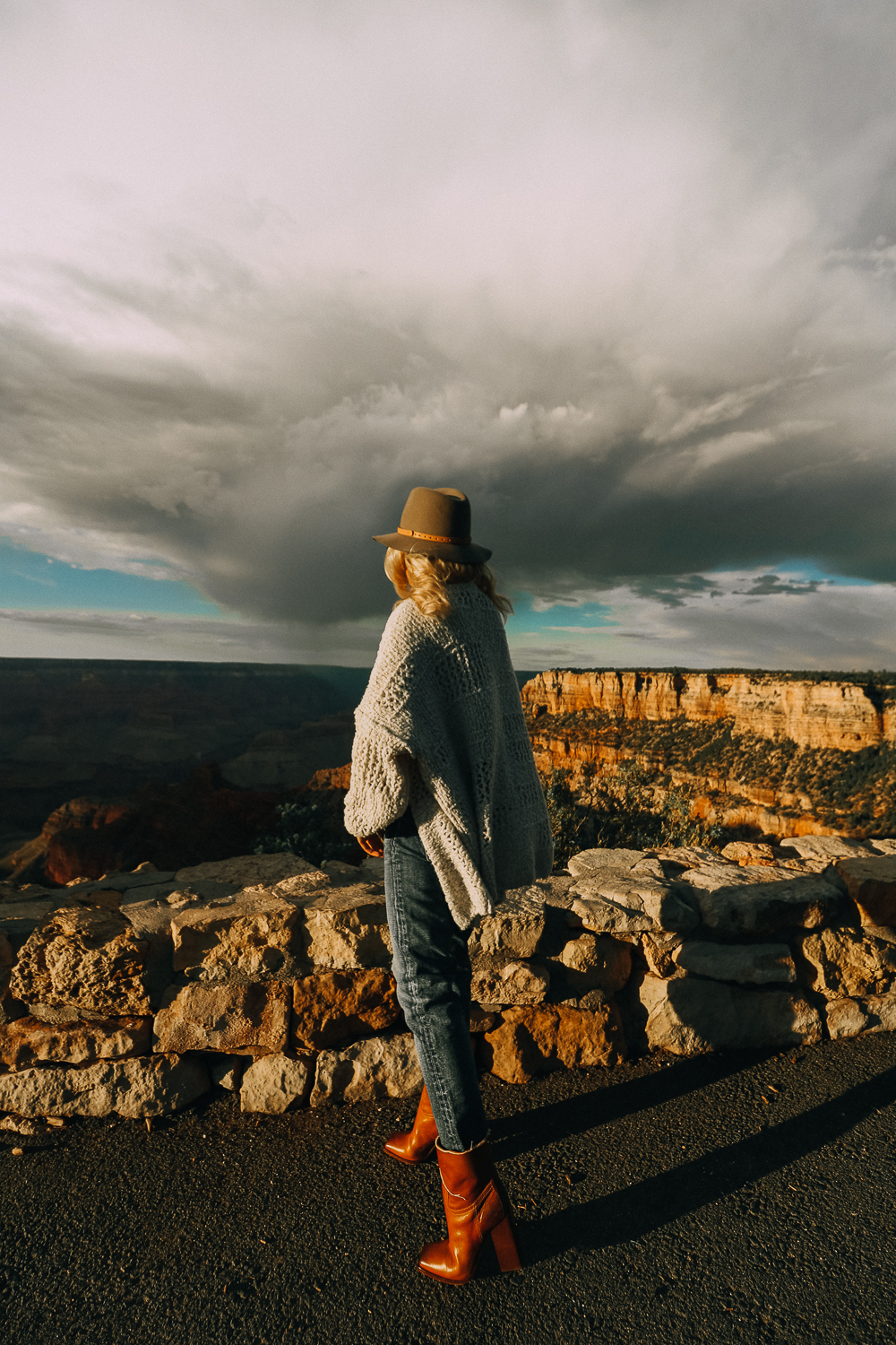 Grand Canyon Rim Trail featuring fashion blogger Erin Busbee of BusbeeStyle.com wearing camel culottes, white turtleneck and a brown hat