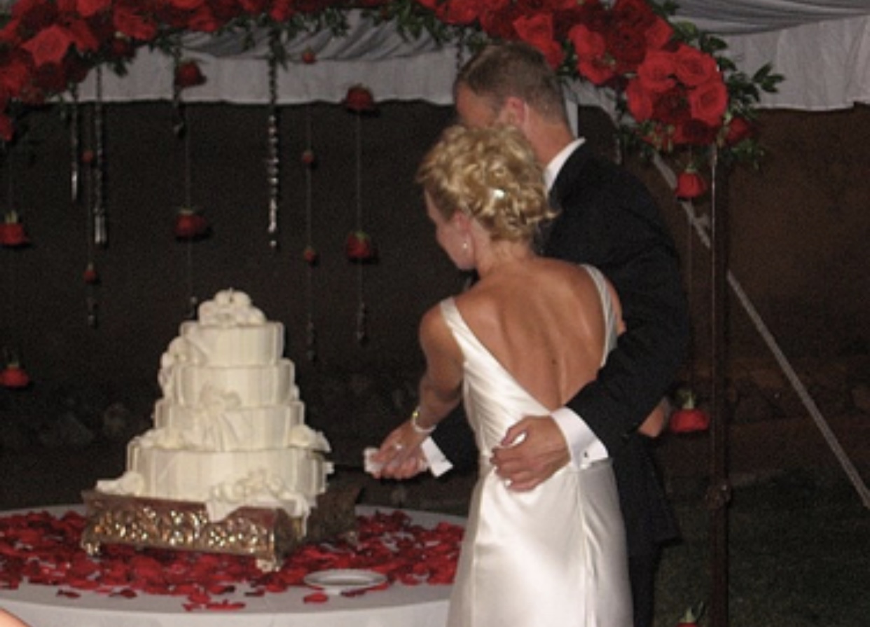 Fashion Blogger Erin Busbee and Husband Chris Cutting Wedding Cake