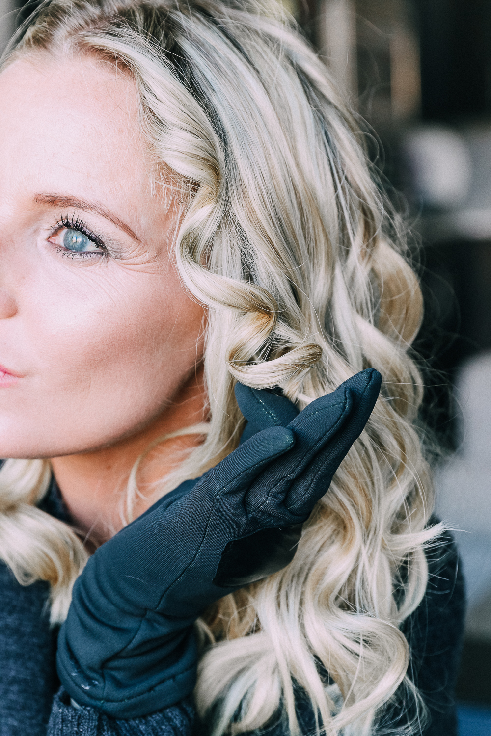 Curling your hair with a wand, step by step instructions by beauty blogger Erin Busbee with long blonde hair