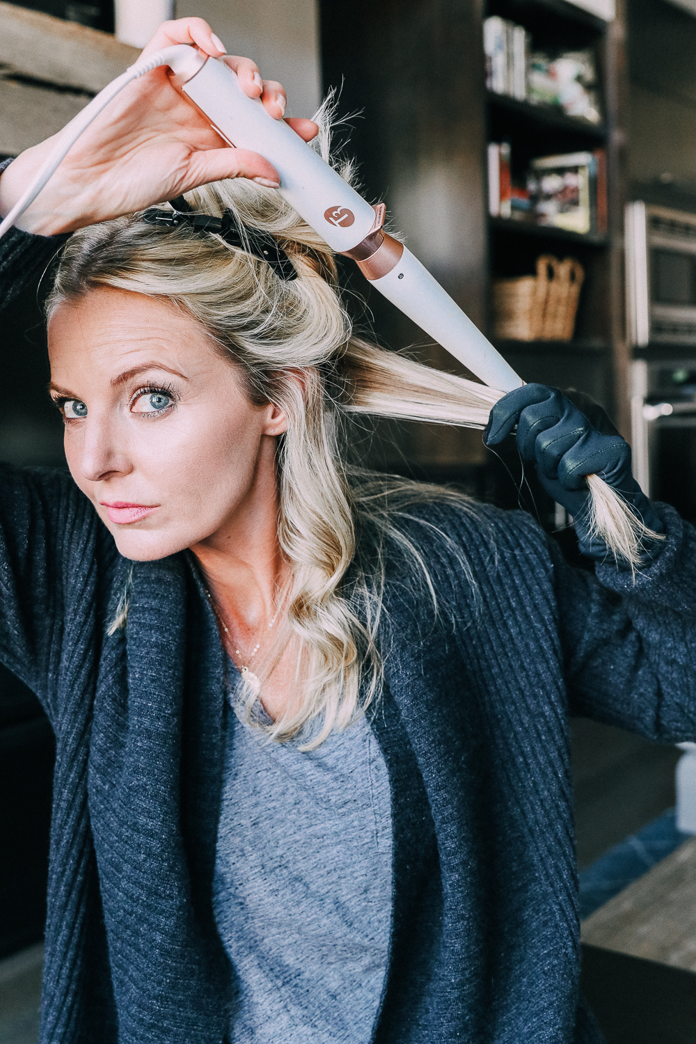Curling your hair with a wand, step by step instructions by beauty blogger Erin Busbee with long blonde hair