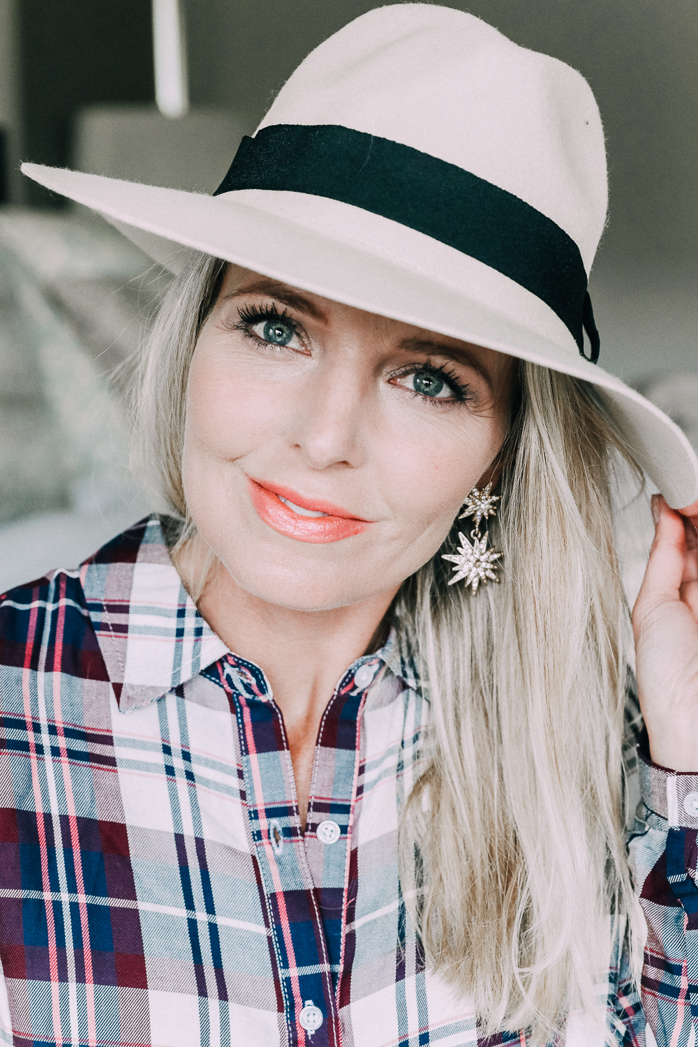 Blonde woman in Colorado wearing hat and plaid shirt from walmart and baublebar earrings showing updating your fall wardrobe under $50