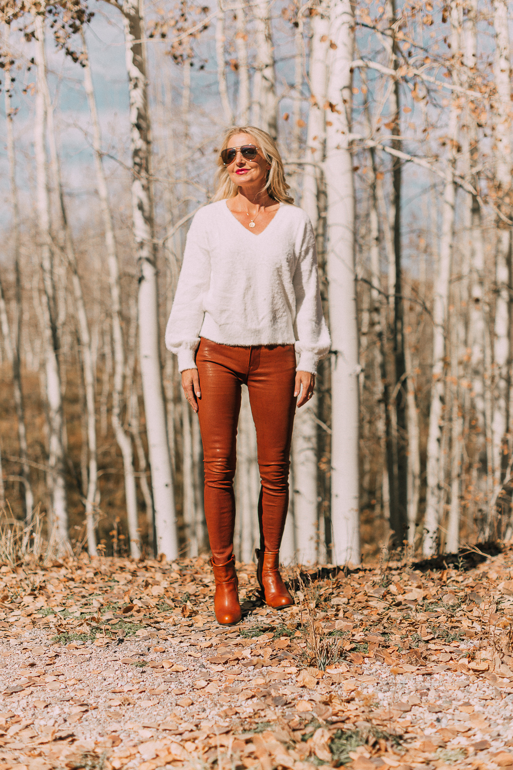sharing how to wear leather pants in these brown frame leather pants and white fuzzy sweater