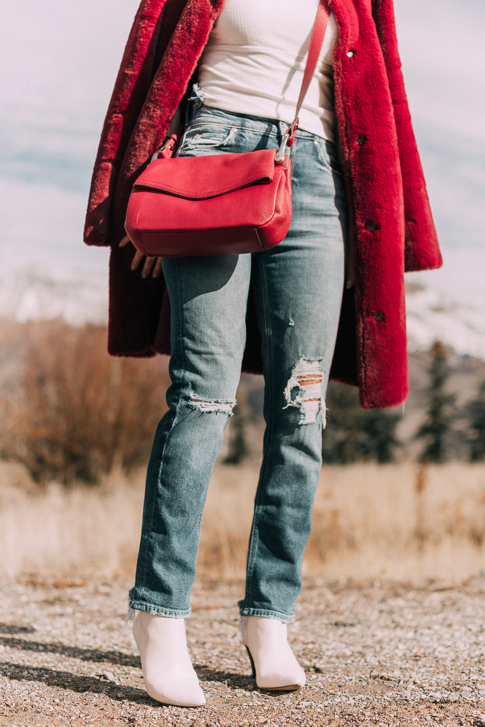 Bootie Trend, how to wear your ankle boots with dresses and jeans featuring white booties with a cone heel by Vince Camuto paired with a reversible faux fur coat, white turtleneck and Mother dazzler jeans