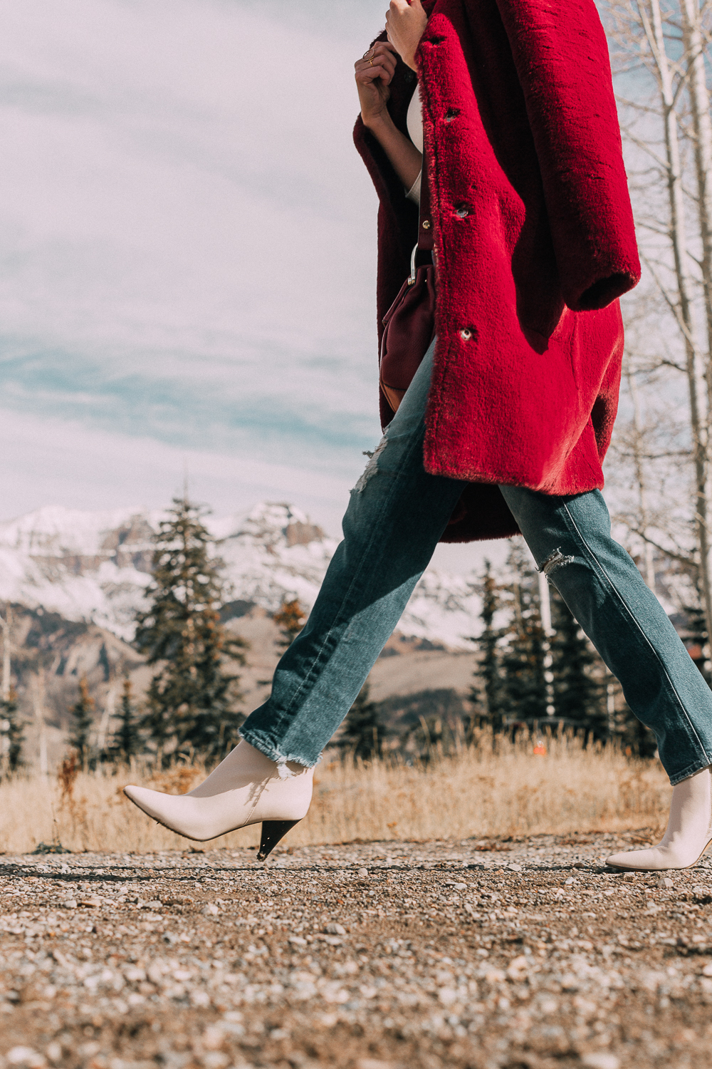Bootie Trend, how to wear your ankle boots with dresses and jeans featuring white booties with a cone heel by Vince Camuto paired with a reversible faux fur coat, white turtleneck and Mother dazzler jeans