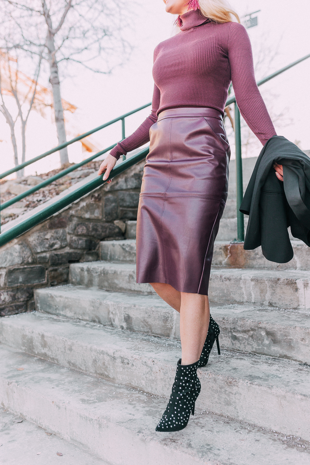What to wear to a holday party when it's cold featuring a faux leather burgundy pencil skirt, ribbed burgundy turtleneck sweater, paired with a black tuxedo blazer and studded stiletto black booties from Express