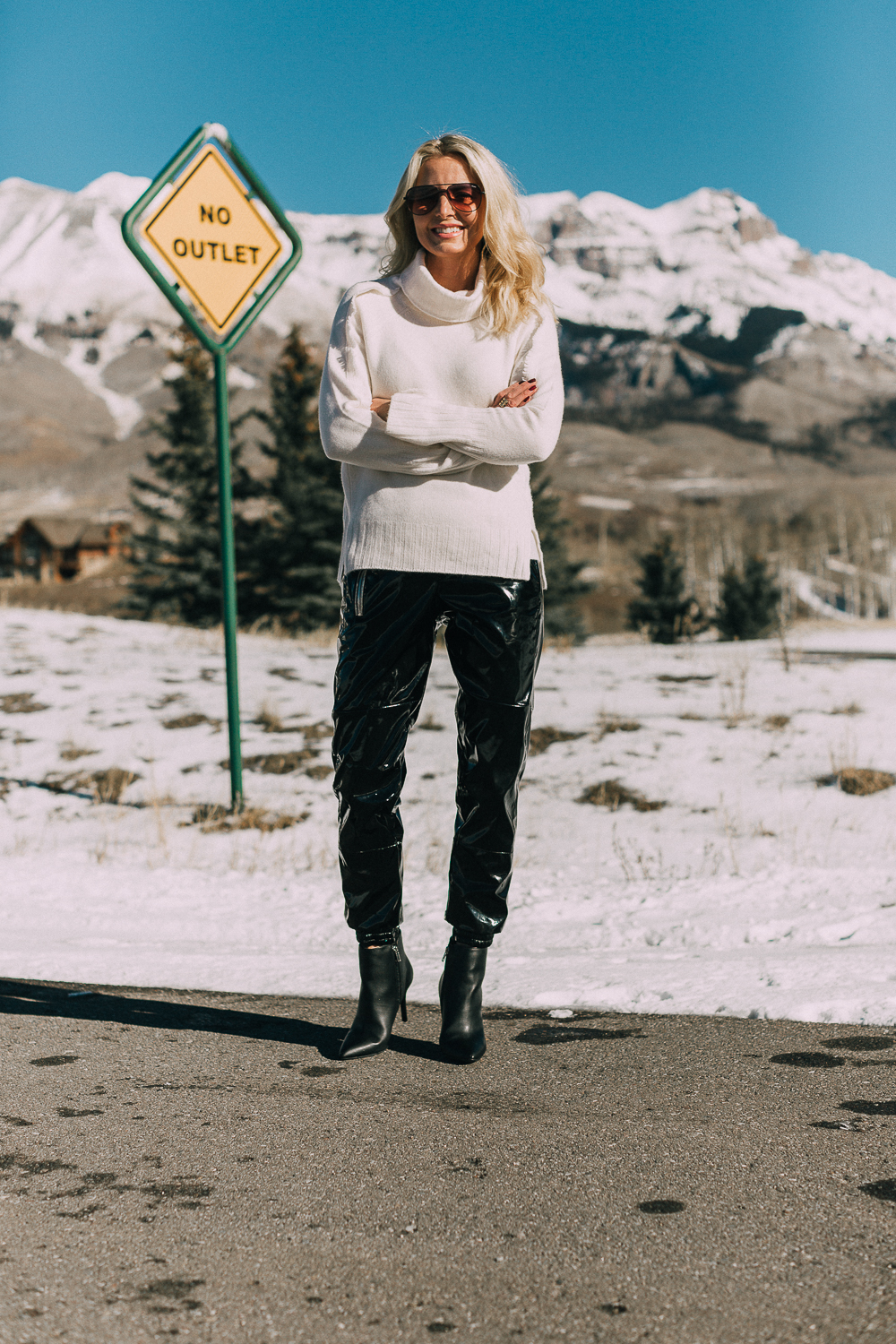 Black vinyl pants by RtA worn with a white turtleneck cashmere sweater by Brochu Walker with black booties by Michael Kors worn by blonde fashion blogger Erin Busbee of Busbee Style