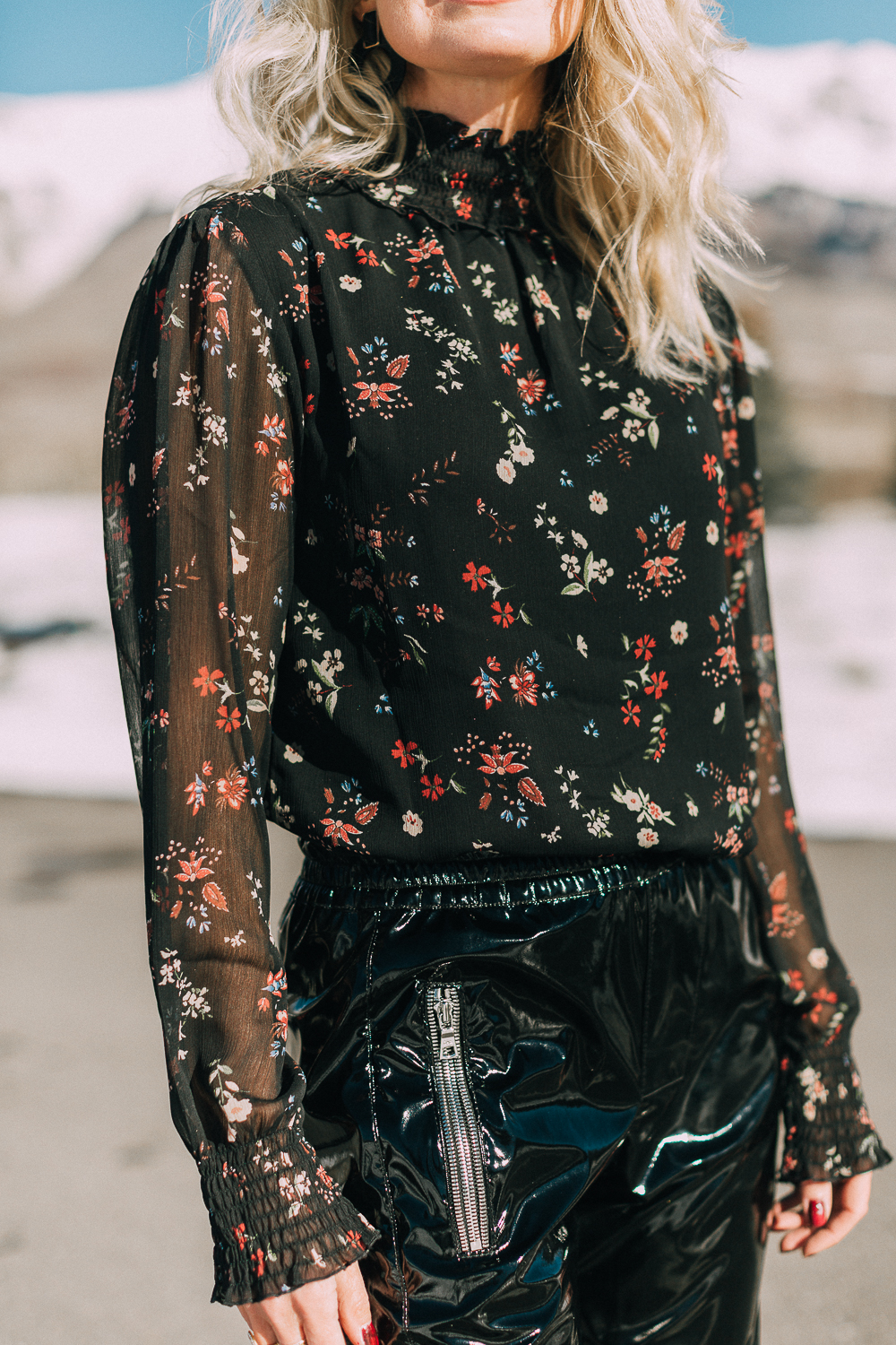Fashion Blogger Erin Busbee of Busbee Style wearing a black floral blouse by Sanctuary tucked in to vinyl pants by RtA