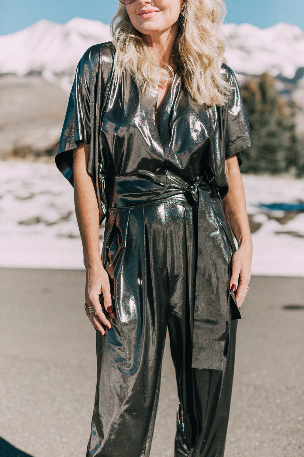 Metallic lamé jumpsuit by Norma Kamali paired with black heels worn by fashion blogger over 40 Erin Busbee of BusbeeStyle.com in Telluride Colorado