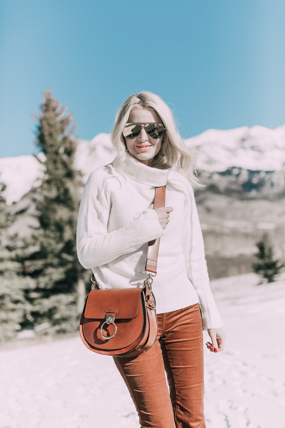 Corduroy Pants by Blank NYC paired with a Brochu Walker White cashmere turtleneck sweater in this monochromatic rust look on fashion blogger over 40 Erin Busbee of Busbee Style in Telluride, Colorado paired with Chloe Tess Bag medium size