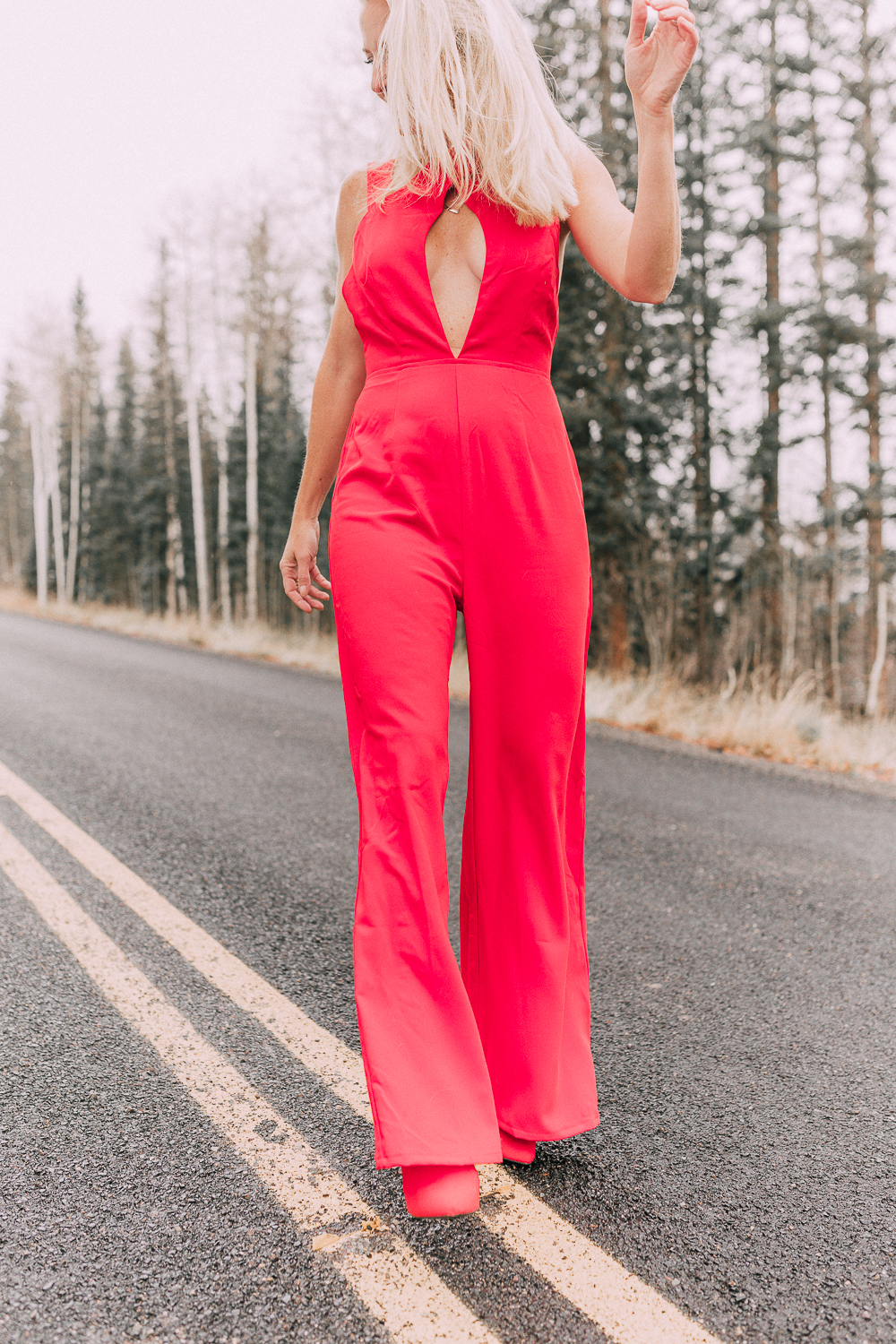 fashion blogger Erin Busbee of Busbeestyle.com wearing by the way red jumpsuit from revolve with keyhole cutout in telluride, colorado