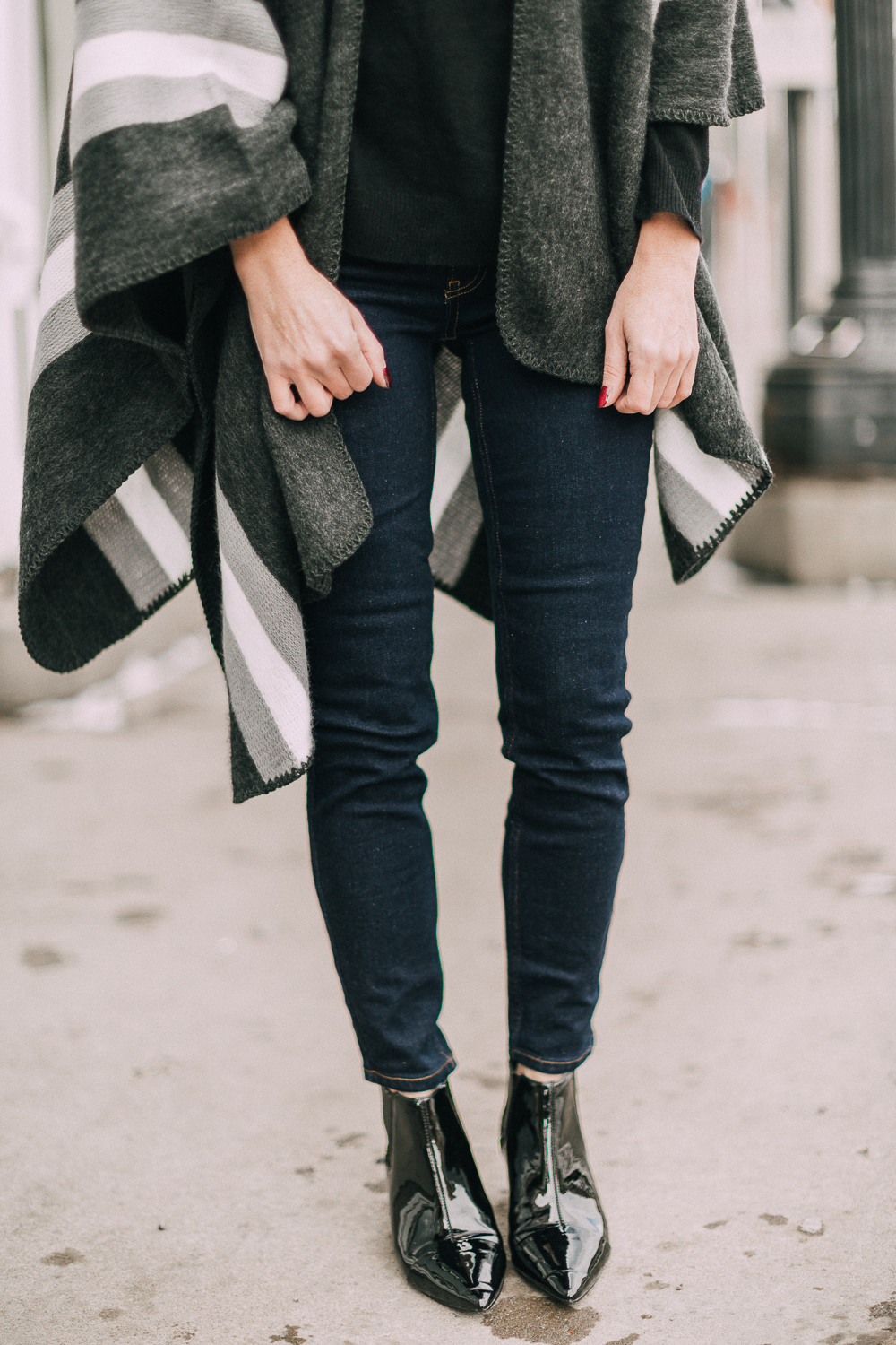 wardrobe staples your closet needs including a black cashmere crewneck sweater and high rise dark wash skinny jeans both from Walmart paired with a poncho and patent booties