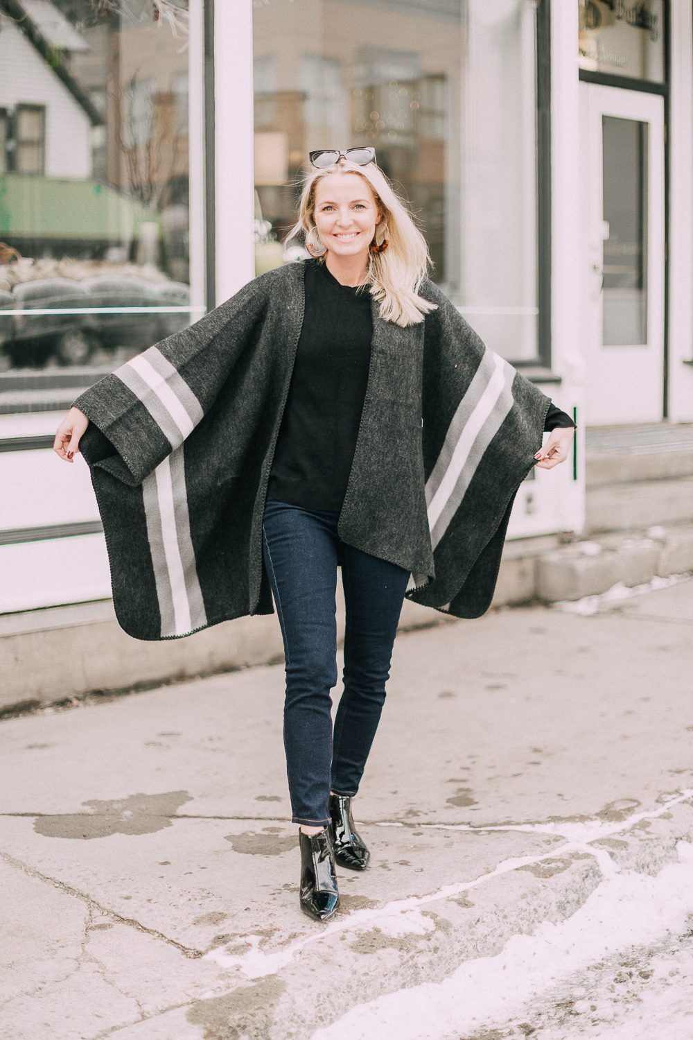 wardrobe staples your closet needs including a black cashmere crewneck sweater and high rise dark wash skinny jeans both from Walmart paired with a poncho and patent booties