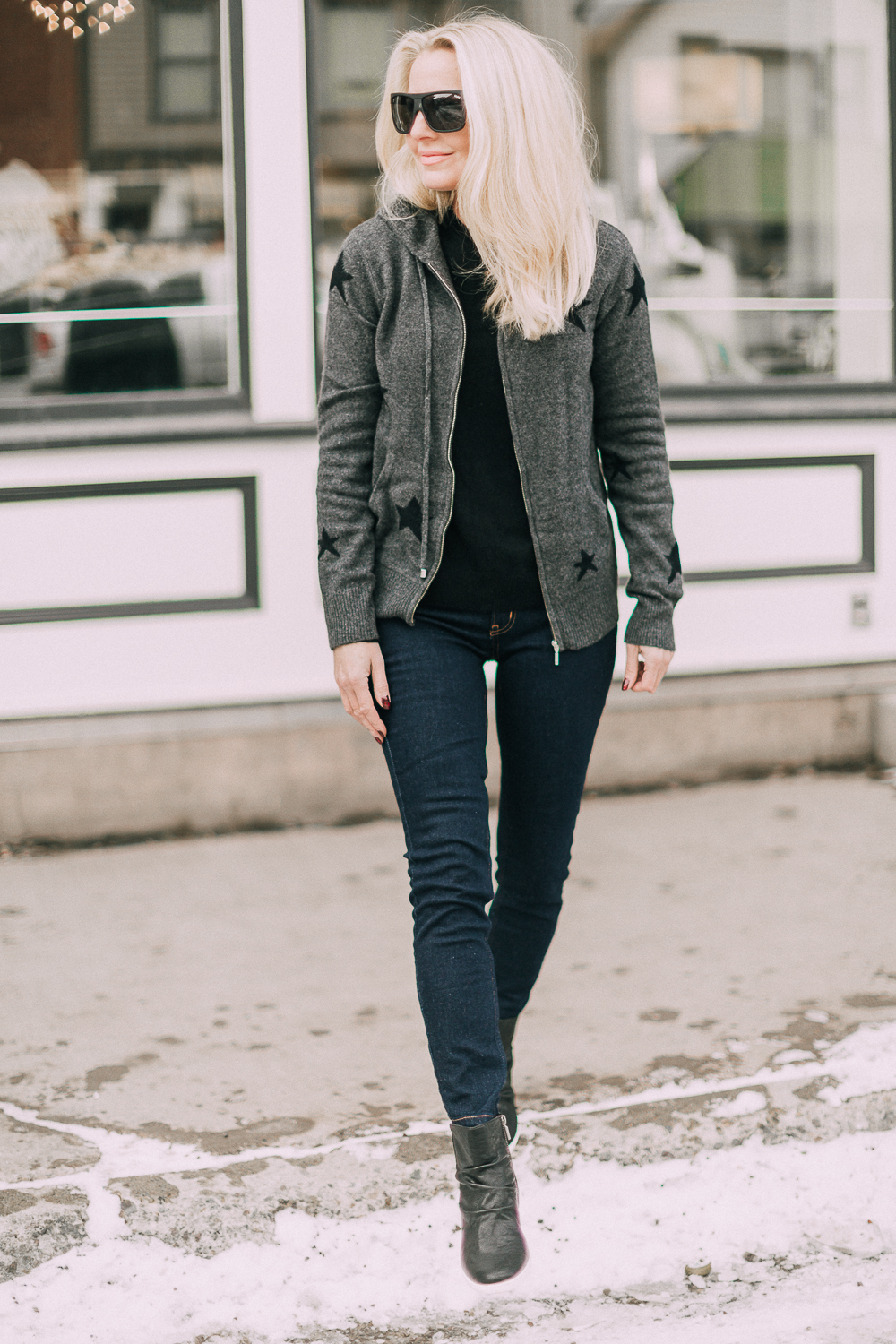 wardrobe staples your closet needs including a black cashmere crewneck sweater and high rise dark wash skinny jeans both from Walmart paired with a cashmere star hoodie and scrunch sneaker boots