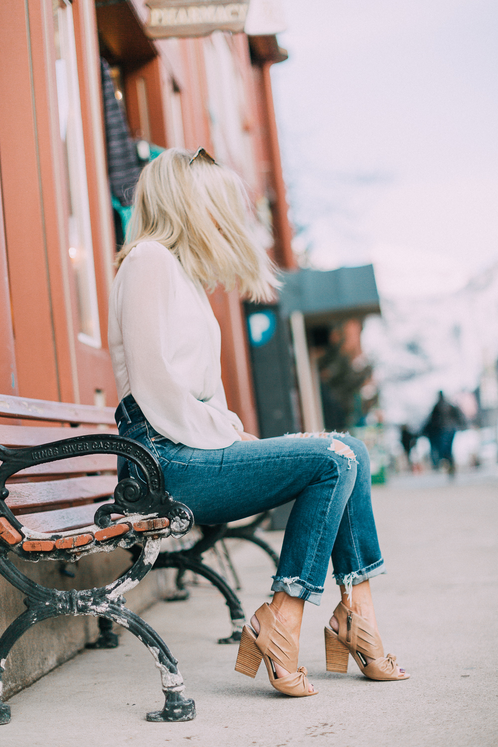 blond woman wearing nude vince camuto heels, mother jeans and grazia top