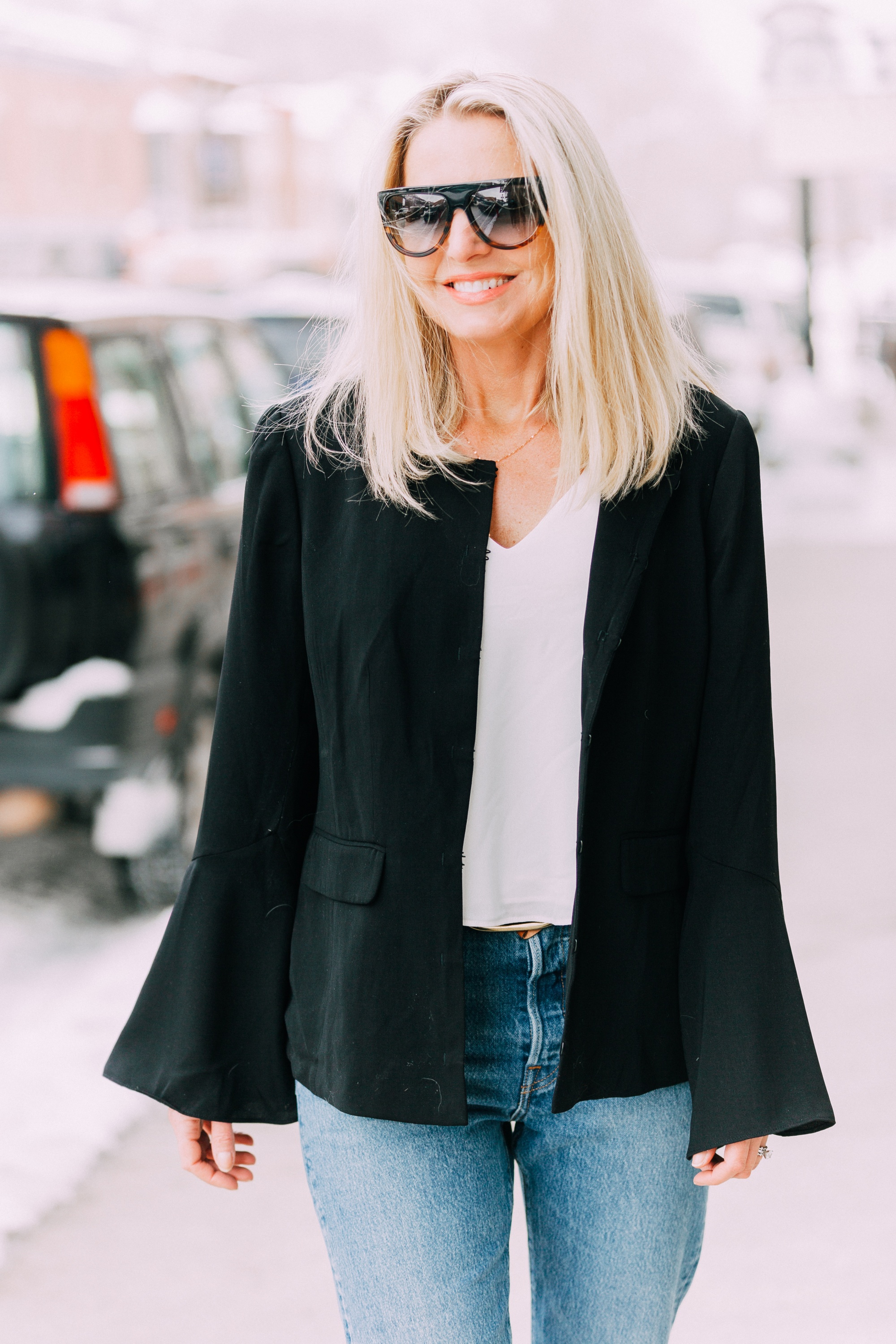 Spring Fashion, Fashion blogger Erin Busbee of BusbeeStyle.com wearing Le Gali black flare sleeve jacket, Levi jeans, AQUA tank, and Via Spiga white mules from Bloomingdale's walking in Telluride, CO