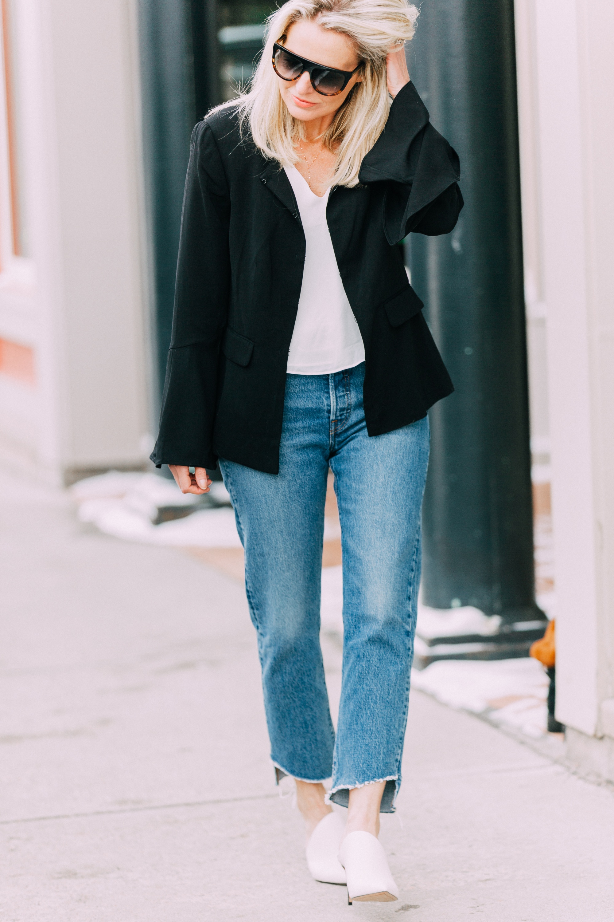 Spring Fashion, Fashion blogger Erin Busbee of BusbeeStyle.com wearing Le Gali black flare sleeve jacket, Levi jeans, AQUA tank, and Via Spiga white mules from Bloomingdale's walking in Telluride, CO